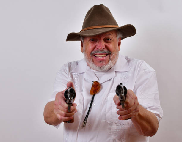 istock Angry senior man aiming two revolvers 1459935888