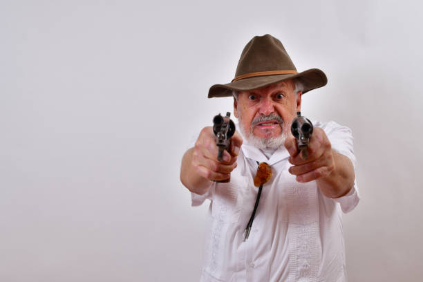istock Angry senior man aiming two revolvers 1459935910