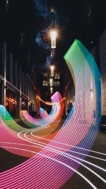istock Image of a road between two buildings with pink long exposured lights. 1459936594