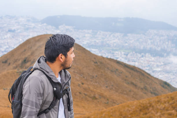 istock Young guy hiking in mountains and enjoying the beautiful view 1459937634