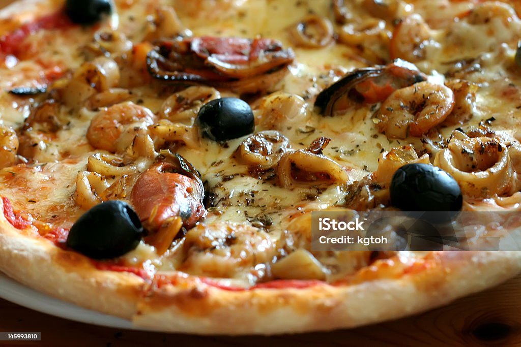 Seafood pizza Traditional italian seafood pizza with prawns and mussels Black Color Stock Photo