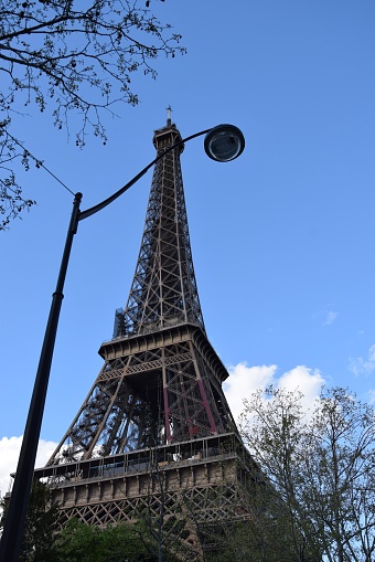 A low-angle vertical shot of Eiffel Tower in Paris, France against a blue sky