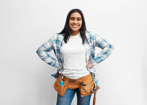 Portrait of a strong young Indian woman about to do DIY at home with tool belt Portrait of a strong young Indian woman about to do DIY at home with tool belt. High quality photo woman wearing tool belt stock pictures, royalty-free photos & images