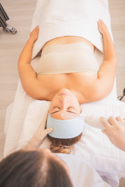 istock Vertical shot of a young Hispanic female getting a face massage at a spa 1459940563