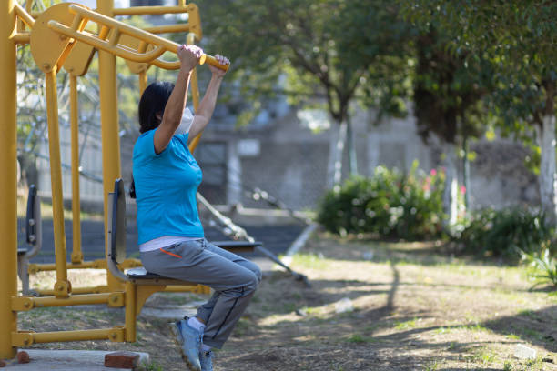 istock Mexican aged femalein a face mask is working out on a playground 1459940761