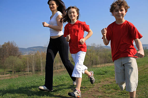 istock A mother and two children running together 145994095