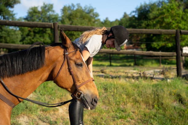 istock Equestrian female holding a horse 1459940956