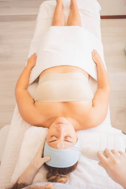 istock Vertical shot of a young Hispanic female getting a face massage at a spa 1459941108