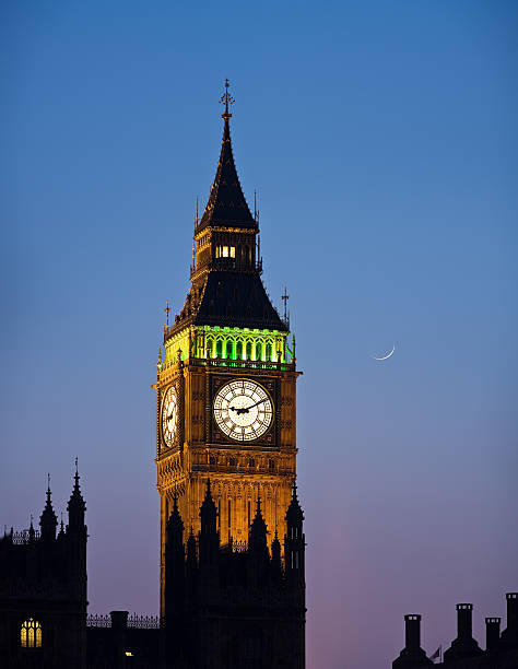 Big Ben at dusk with crescent moon stock photo