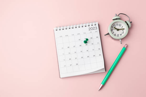 istock Calendar with pinned date and clock on pastel pink background, planning and scheduling concept 1459945095