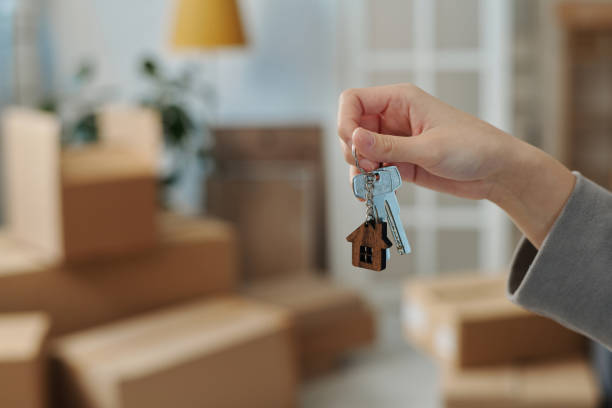 istock Woman holding keys from new house 1459945422