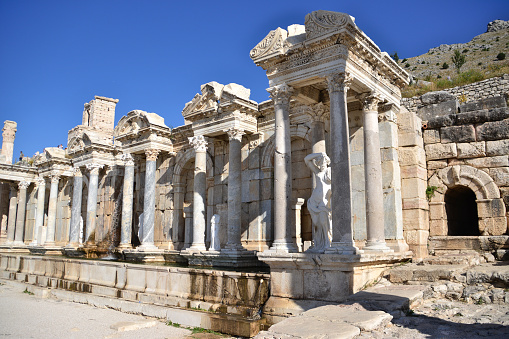 ancient fountain with columns and greek statues of ancient town Sagalassos isolated, close-up