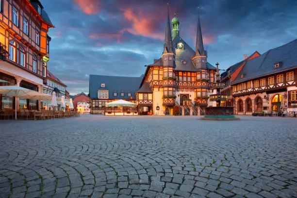 Cityscape image of historical downtown of Wernigerode, Germany with Old Town Hall at summer sunrise.