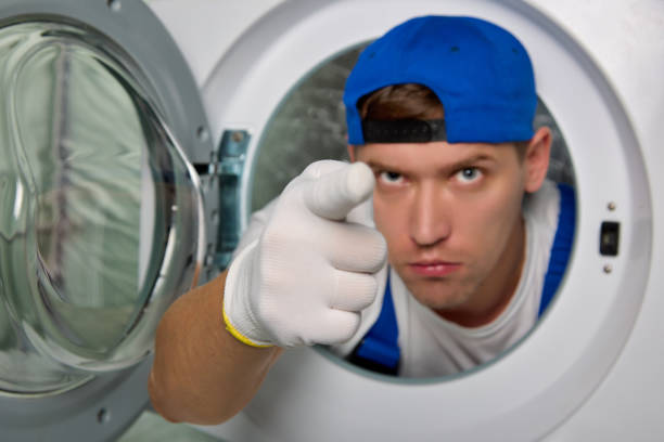 istock Angry washing machine repairman pokes sternly at camera with his index finger 1459948145