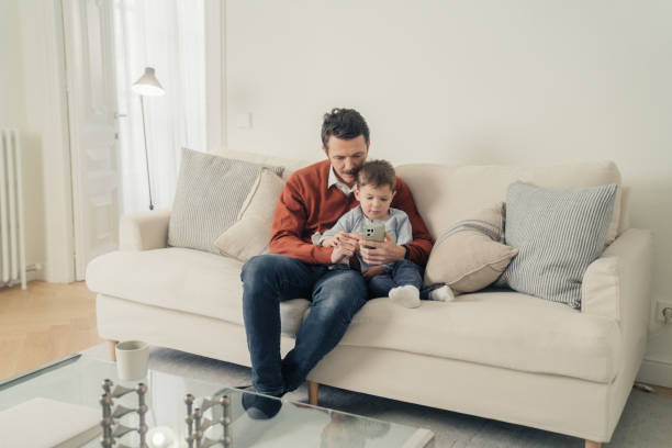istock Father and son having a video call with cellphone 1459949868
