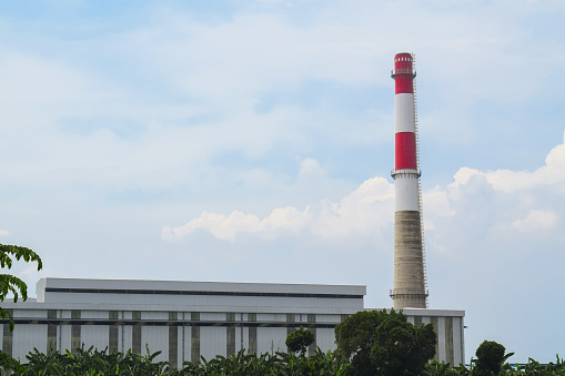 Thermal power plant with smoking chimneys. Industrial landscape. isolated blue sky background