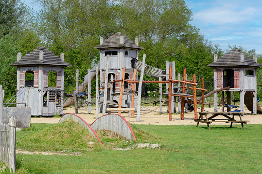 Children's eco playground in Europe. Several wooden houses for children on the ecological playground on the summer day