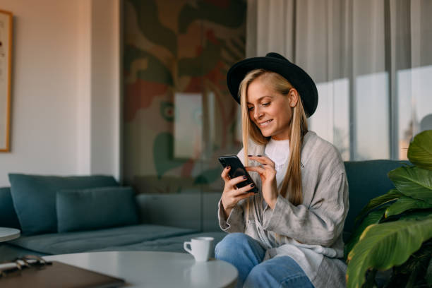 istock Woman with a long blonde hair using a phone during a break from work. 1459954149