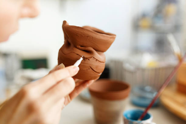 istock Female hands hold a bowl for casting clay products. Shaped method for making clay dishes. Handwork. Pottery making 1459955074