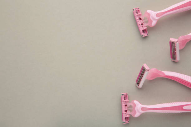 istock Pink razors for hair removal on grey background 1459955968