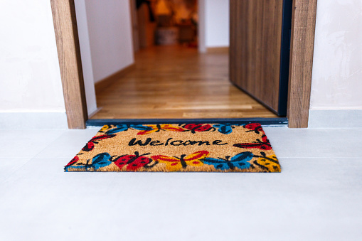 Welcome doormat in front of the door on entrance in new home