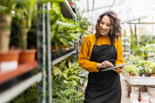 istock Young woman working at garden center 1459957570