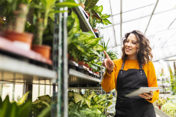 istock Young woman florist checking inventory 1459957574
