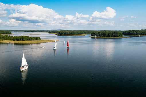 Masuria. Aerial view of green islands and clouds at summer sunny day. Masurian Lake District in Poland.