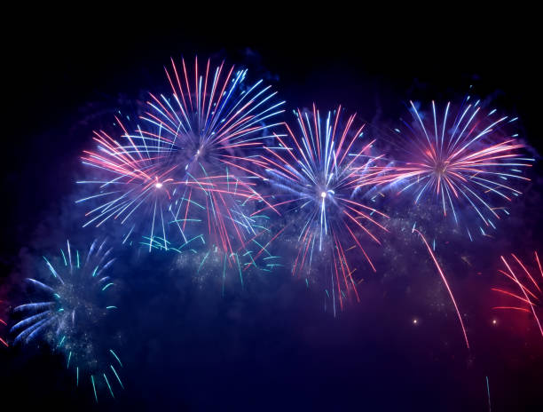 istock Beautiful blue and pink fireworks display lights up the sky with dazzling display during New Year celebration. Abstract colored fireworks background, copy space. Celebration and anniversary concept 1459960205