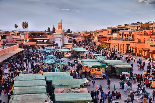 People visit Jemaa el-Fnaa square market of Marrakesh city, Morocco. The square is listed as UNESCO Masterpiece of Intangible Heritage of Humanity.