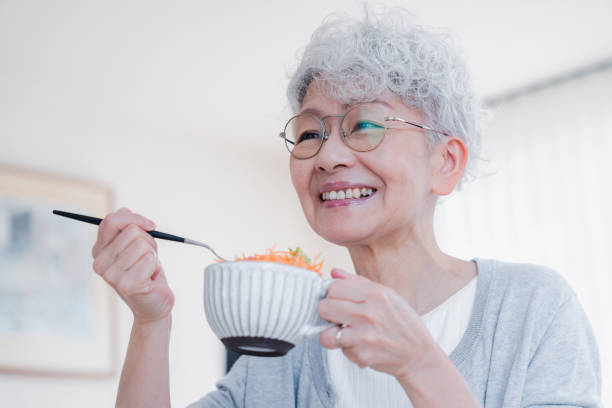 istock Senior woman eating breakfast with a smile 1459962335