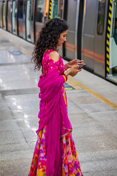 istock Indian girl using a mobile phone at metro station, India 1459965512