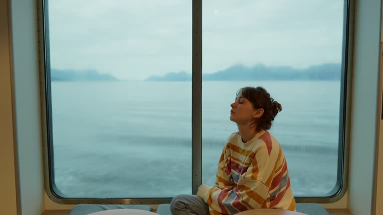 Portrait of woman traveling by ferry in Norway