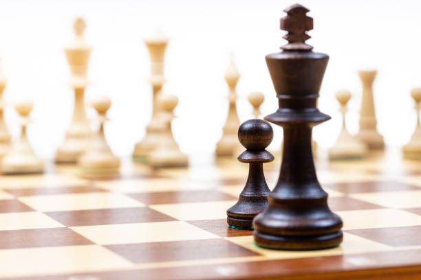 istock black pawn and queen against white chess pieces 1459966646