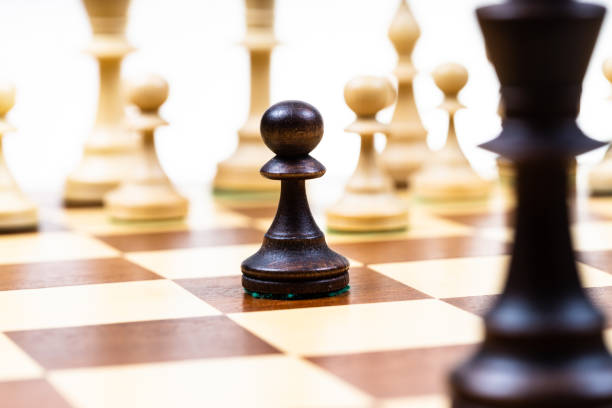 istock attacking black pawn and queen against white chess 1459966653