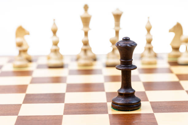 istock black queen against white chess pieces close up 1459967171