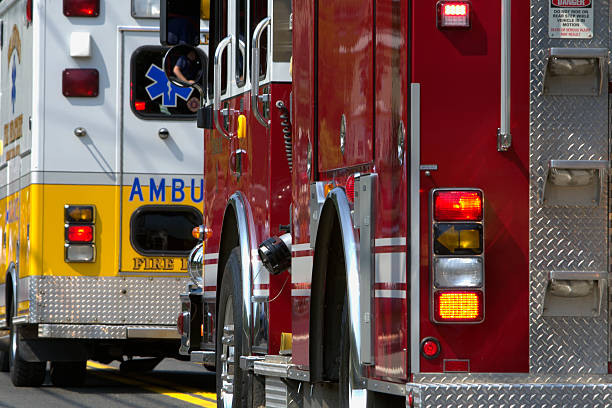 Emergency Vehicles Several emergency vehicles lined up, some with lights flashing. ambulance stock pictures, royalty-free photos & images