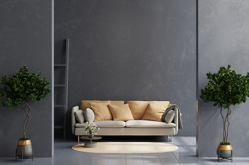 Mockup dark cement wall with gray sofa and decor in living room.3d rendering
