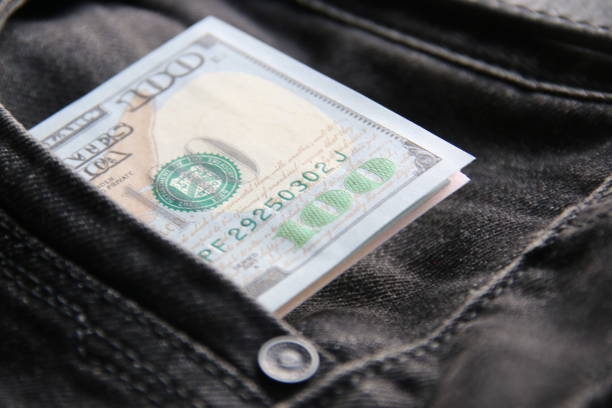 istock American dollars USD banknotes in jeans pocket. 1459975834