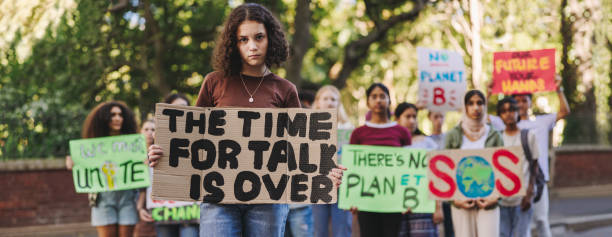 istock Young girl leading a march against climate change 1459976855