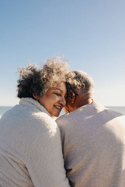 istock Elderly woman smiling happily while sitting with her husband 1459977155