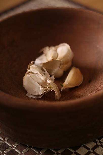 Garlic pieces in a bowl stock photo