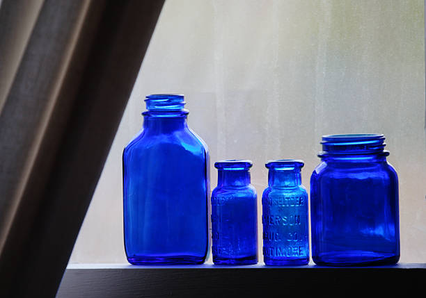 istock Blue medicine bottles on window sill 145997892