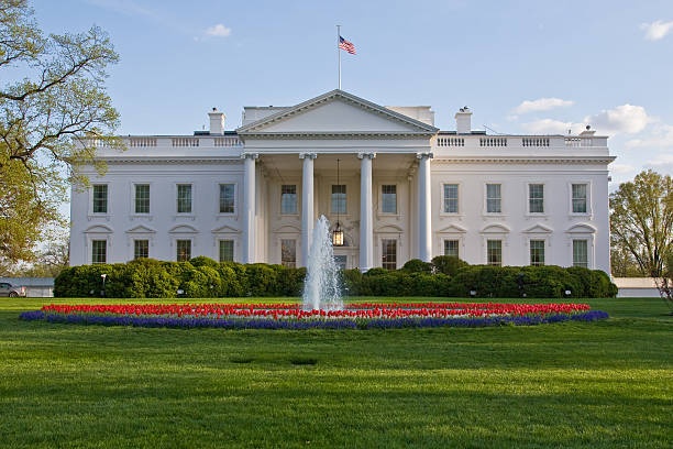 istock Front view of a White House featuring a fountain out front 145997944