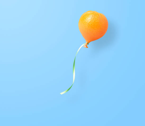 Fresh orange balloon concept on blue. This file is cleaned and retouched.
