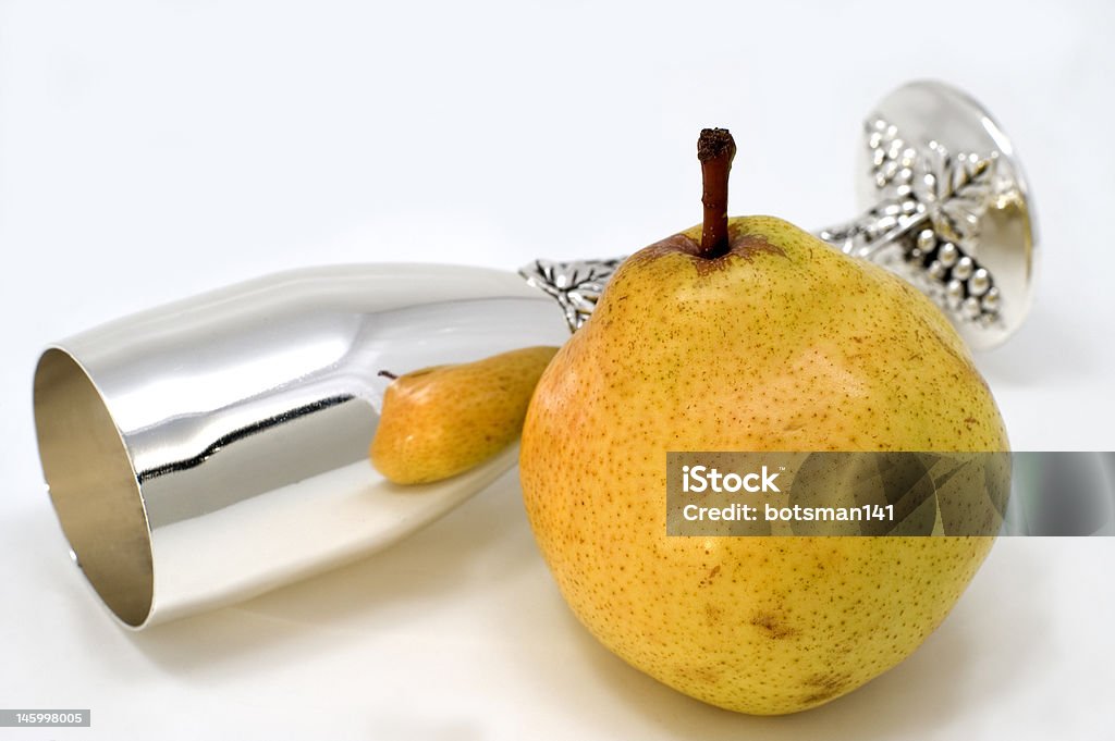 Pear White glass and green pear on a white background. Food Stock Photo