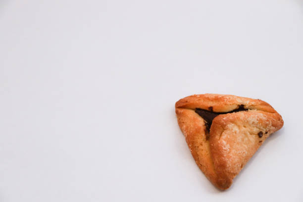 istock Hamantash (Ozen Haman), an Ashkenazi Jewish triangular filled-pocket pastry traditionally eaten during Purim holiday isolated on white background 1459985865