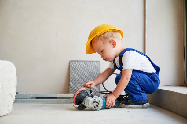 istock Child using electric power tool in apartment under renovation. 1459990114