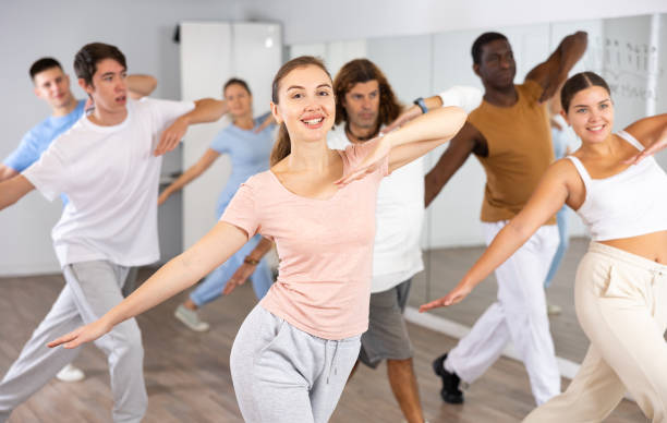 istock Happy active energetic multiracial dancers of different ages dancing aerobics at lesson in modern class studio 1459990841