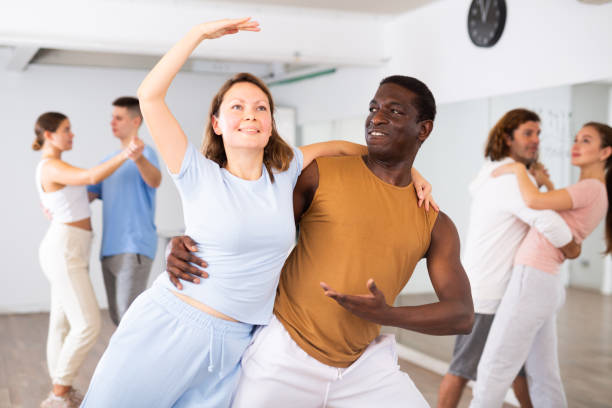 istock Woman and man practicing bachata dance moves in pair during group modern class 1459991064